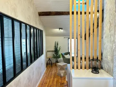 a living room with a staircase and windows at Le Scandinave in Aix-en-Provence