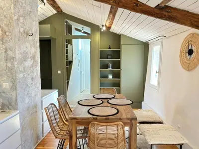 a dining room with a wooden table and chairs at Le Scandinave in Aix-en-Provence
