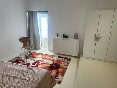 a bedroom with a bed and a rug on the floor at Le mazet in Pélissanne
