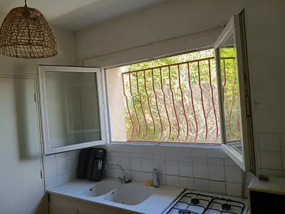 a bathroom with a sink and a window at Studio privé confortable avec terrasse, parking et Wi-Fi in Aix-en-Provence