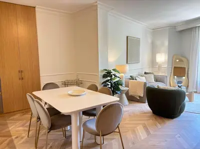 a living room with a table and chairs and a couch at Le Pénélope in Aix-en-Provence