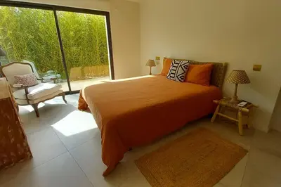 a bedroom with a large bed and a large window at Appartement Indépendant avec Jardin et Piscine en Provence in Ventabren