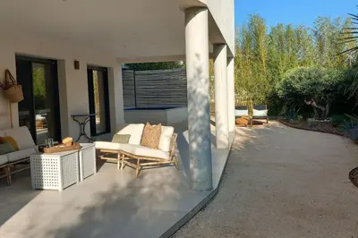 a patio with couches and chairs in a house at Appartement Indépendant avec Jardin et Piscine en Provence in Ventabren