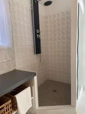 a shower with a glass door in a bathroom at Studio Estrella - Studio 2 personnes - Domaine Astra, Grans in Grans