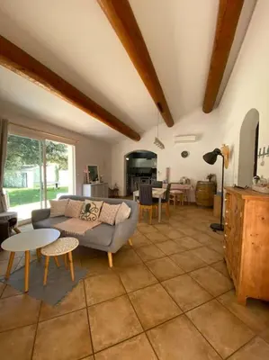 a living room with a couch and a table at Maison de Vacances en Provence in Venasque
