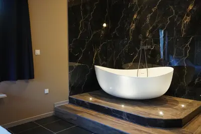 a large white tub sitting on a counter in a bathroom at La Villa Astra de 4 à 12 personnes - Domaine Astra, Grans in Grans