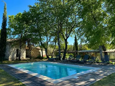 a swimming pool in the yard of a house at Chambre dans bastide au milieu des vignes in Ménerbes