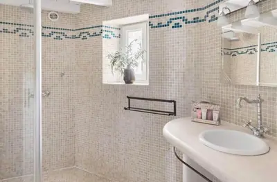 a white bathroom with a shower and a sink at Chambre dans bastide au milieu des vignes in Ménerbes