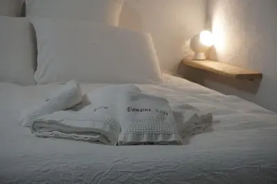 a white blanket sitting on top of a bed at La Maison Alma - de 4 à 12 personnes - Domaine Astra, Grans in Grans
