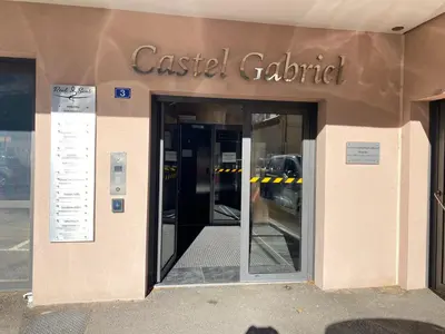 a building with the entrance to a caslabel gatedartment at T3 au pied des Tours du Château in Châteaurenard