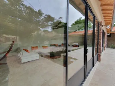 a glass extension of a house with a patio at Le grand mas du Couchadou in Pernes-les-Fontaines