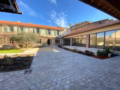 a brick walkway in front of a building at Le grand mas du Couchadou in Pernes-les-Fontaines