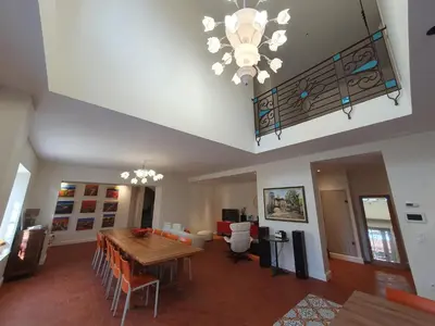 a dining room with a table and a chandelier at Le grand mas du Couchadou in Pernes-les-Fontaines