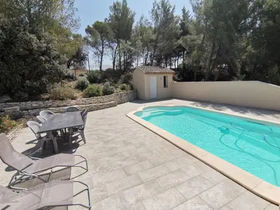 a patio with a pool and a table and chairs at Escapade en maisonnette indépendante avec piscine in Châteaurenard