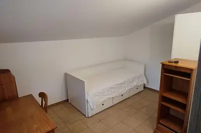 a bedroom with a bed in the corner of a room at Escapade en maisonnette indépendante avec piscine in Châteaurenard