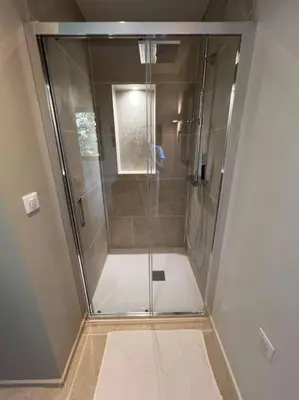 a shower with a glass door in a bathroom at L'appart du mas du Zébu Bleu in Vernègues