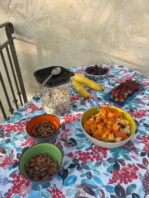 a table with bowls of fruit and nuts on it at Au Clair Ventoux B & B - SPA in Saint-Didier