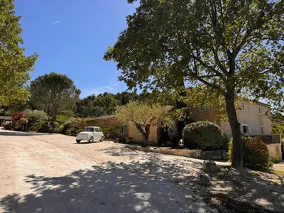 a white car parked in front of a house at Au Clair Ventoux B & B - SPA in Saint-Didier