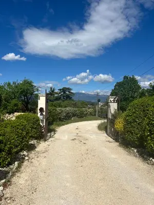 a dirt road with a gate on the side at Au Clair Ventoux B & B - SPA in Saint-Didier