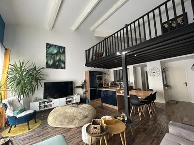 a living room with a staircase and a table and chairs at Magnifique Duplex à proximité Aix en Provence in Éguilles