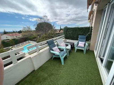 a patio with chairs and a table on a balcony at Magnifique Duplex à proximité Aix en Provence in Éguilles