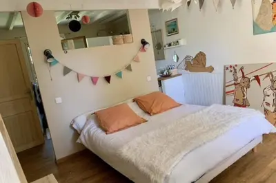 a bedroom with a bed and a wall with flags at House with swimming pool and breathtaking views of the Luberon in Robion en Luberon