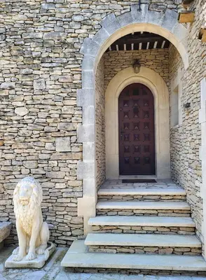 a lion statue in front of a building with a door at 