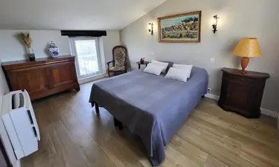 a bedroom with a bed with a blue comforter at 