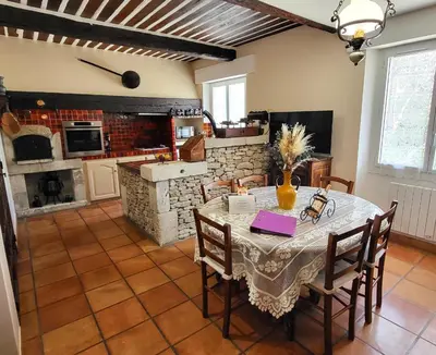 a dining room with a table and chairs and a kitchen at 