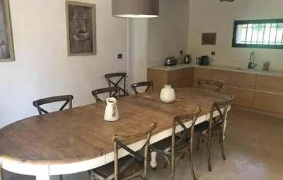 a dining room table with chairs and vases on it at Lovely Home In Le Thor With Wifi in Le Thor