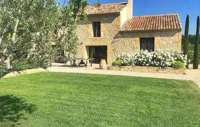 a stone house with a lawn in front of it at Lovely Home In Le Thor With Wifi in Le Thor