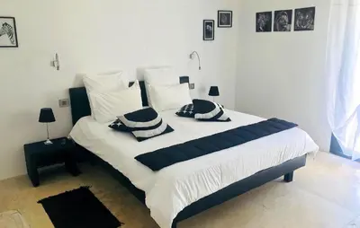 a bedroom with a bed with black and white pillows at Lovely Home In Le Thor With Wifi in Le Thor