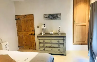 a bedroom with a dresser and a wooden door at Lovely Home In Le Thor With Wifi in Le Thor