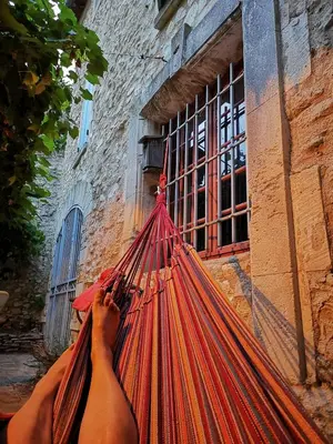 a person holding a net in front of a building at Maison provençale, piscine, calme et Lubéron in Le Thor