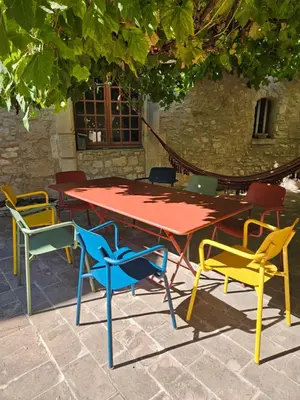 a group of chairs around a table and a table and chairs at Maison provençale, piscine, calme et Lubéron in Le Thor