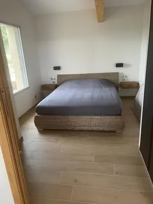a bedroom with a bed in the corner of a room at logement avec jacuzzi in Joucas