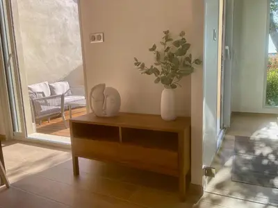 a table with a vase with a plant on it at logement avec jacuzzi in Joucas