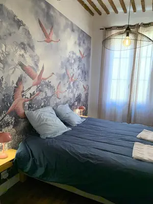 a bedroom with a blue bed with birds on the wall at Rotonde, 2 chambres, Air conditionné in Aix-en-Provence