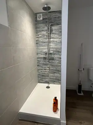a shower stall in a bathroom with a toilet at Logis du Vert Moulin Premium in Le Puy-Sainte-Réparade