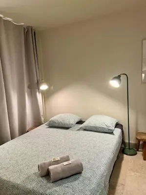 a bed with two pillows and a towel on it at Appartement au coeur du centre historique in Aix-en-Provence