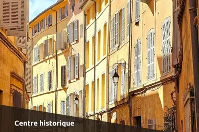 an alley in a city with buildings with windows at Le Saint Sauveur - Centre Ville - Calme - Lumineux in Aix-en-Provence