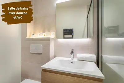 a bathroom with a sink and a mirror at Le Saint Sauveur - Centre Ville - Calme - Lumineux in Aix-en-Provence