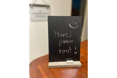 a chalkboard sign sitting on top of a table at Le Saint Sauveur - Centre Ville - Calme - Lumineux in Aix-en-Provence