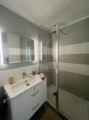 a bathroom with a sink and a glass shower at Terrasse à Aix en Provence centre historique in Aix-en-Provence