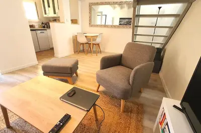 a living room with a chair and a table at Terrasse à Aix en Provence centre historique in Aix-en-Provence