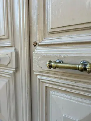 a gold doorhandle on a white wooden door at Appartement spacieux en Provence in Châteaurenard