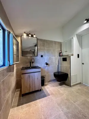 a bathroom with a sink and a toilet and a mirror at Ferme de restantier, love room in La Tour-dʼAigues