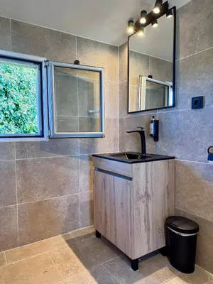a bathroom with a sink and a mirror at Ferme de restantier, love room in La Tour-dʼAigues
