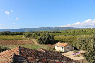 a view of a farm with a building and a field at Ferme de restantier, love room in La Tour-dʼAigues