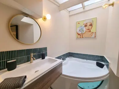 a bathroom with a white sink and a mirror at 25 rue Celony - Le Vendome - Jacuzzi - VideoProjecteur in Aix-en-Provence